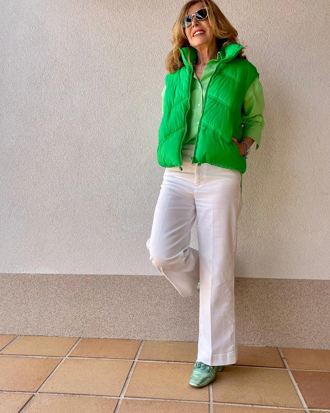 Bright green padded vest with white trousers and green shoes