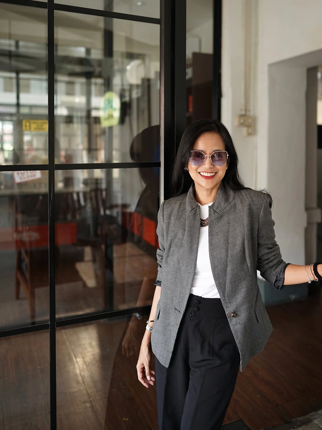 Gray blazer with white top and wide black trousers