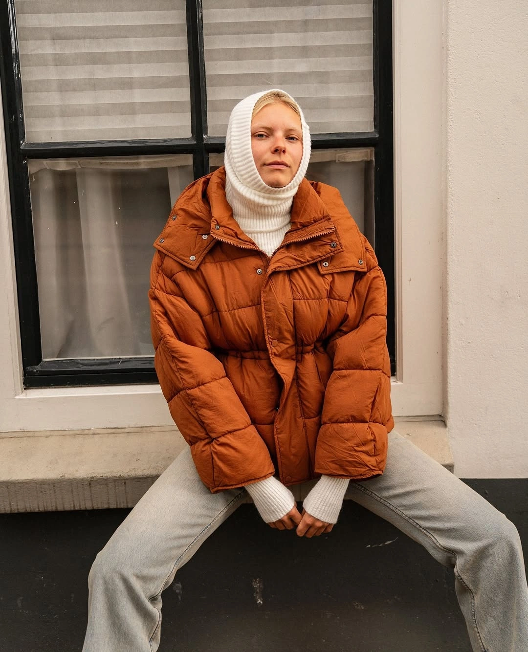 Burnt orange short puffer with ivory hooded knit layer