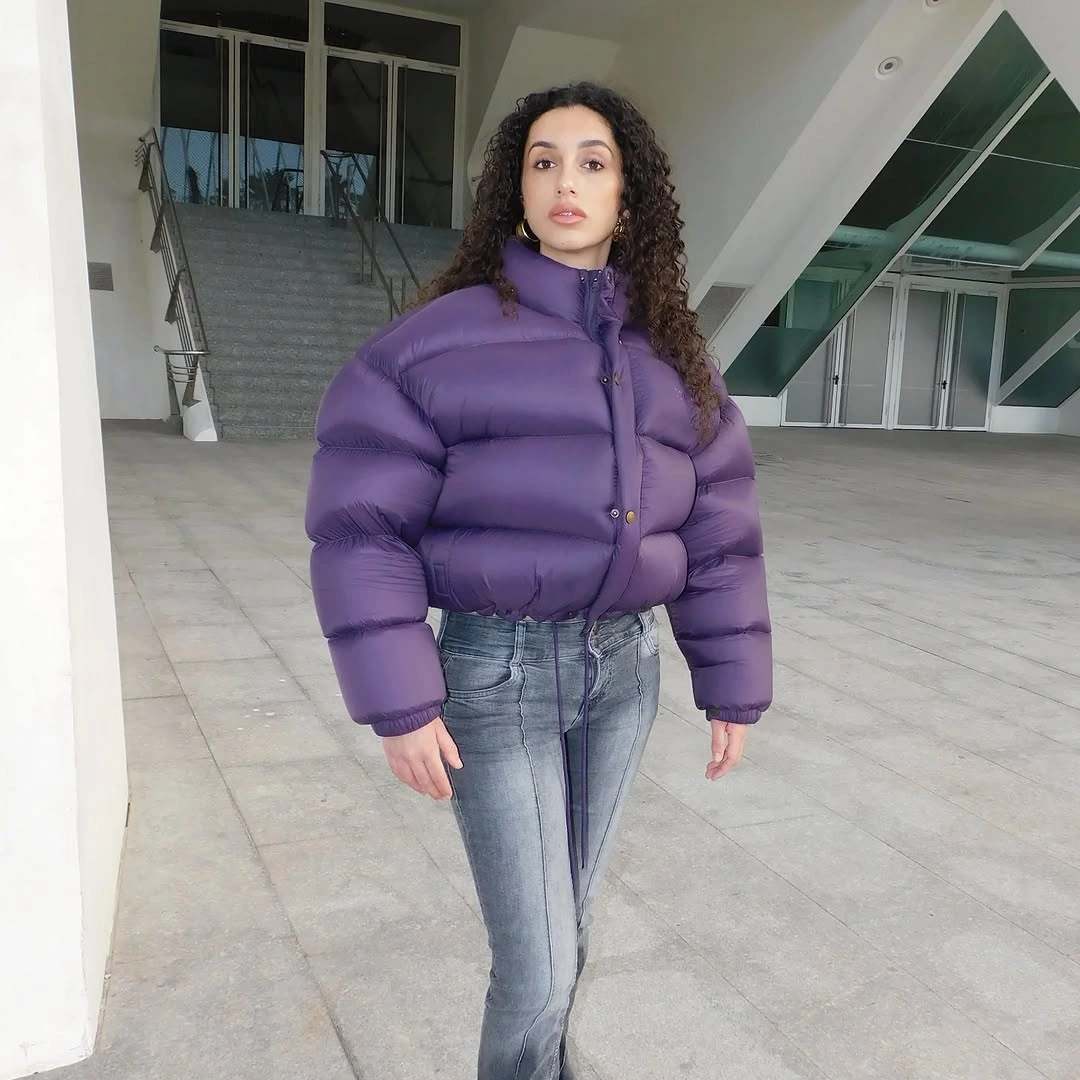 Purple cropped puffer jacket with gray-blue straight jeans