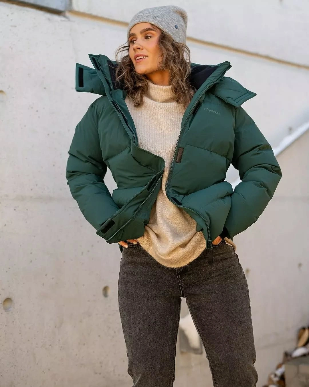 Deep green cropped puffer with cream knit and gray beanie