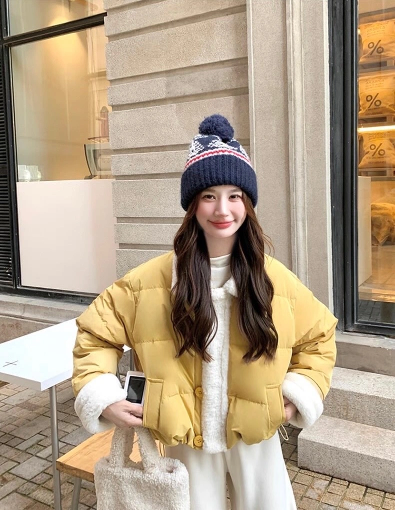 Pale yellow cropped puffer with cream layers and patterned hat