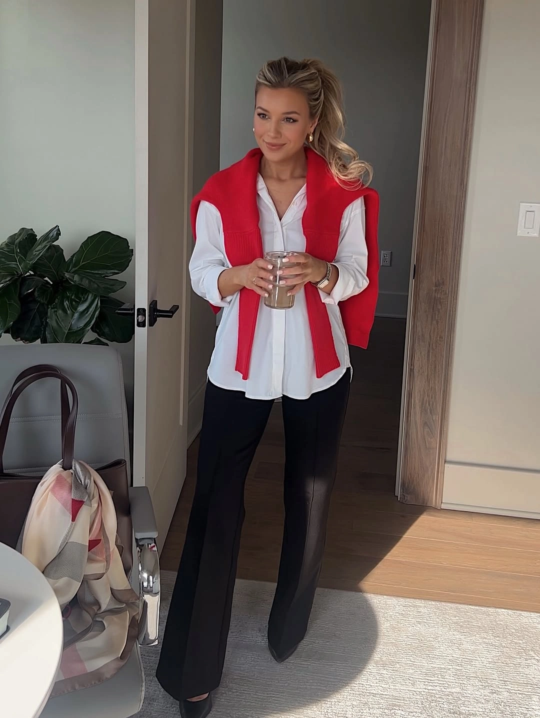 White shirt with red shoulder layer and black flared trousers