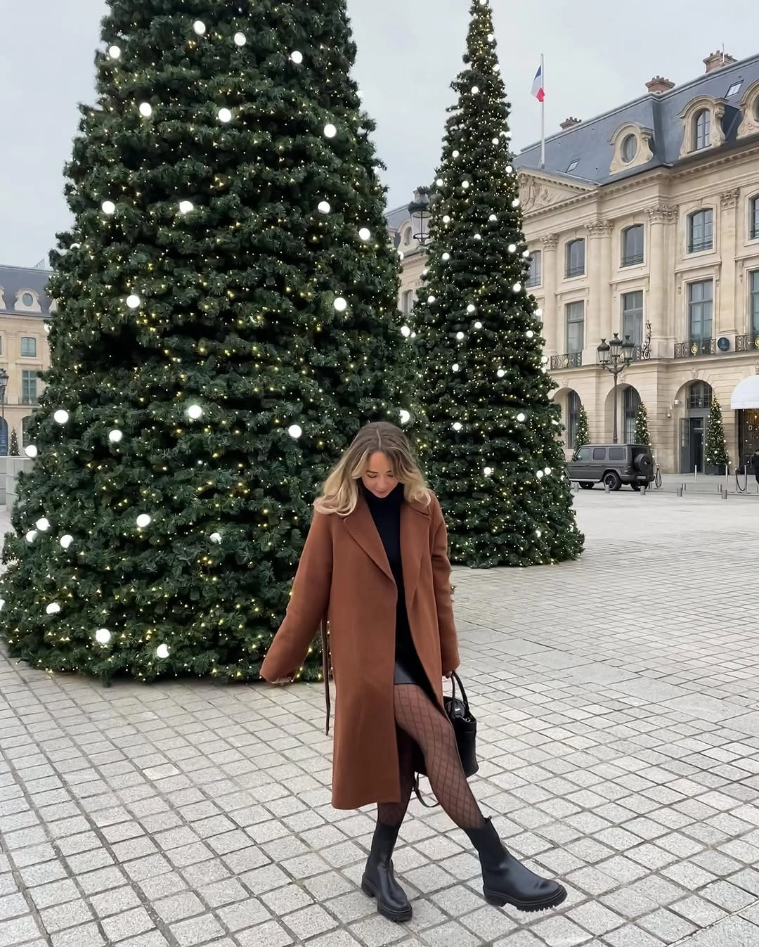 Long brown coat with patterned tights and chunky black boots