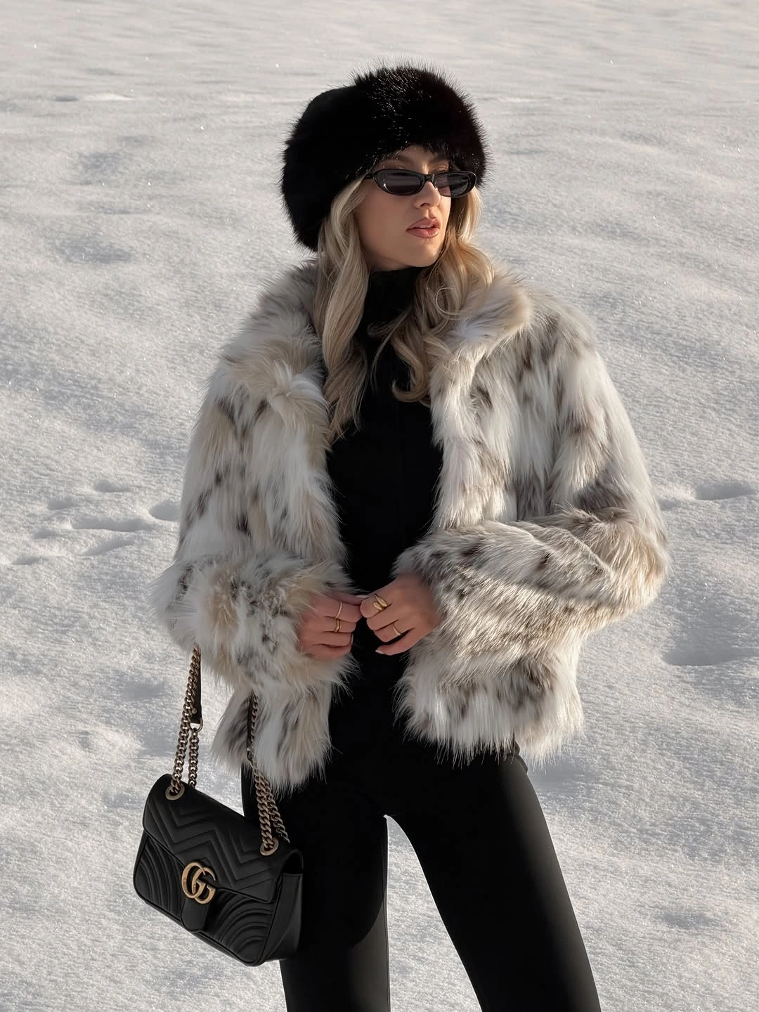 Pale plush cropped jacket with black top and slim trousers