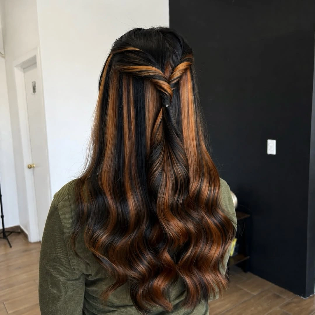 Dark long hair with broad caramel panels and half-up twist