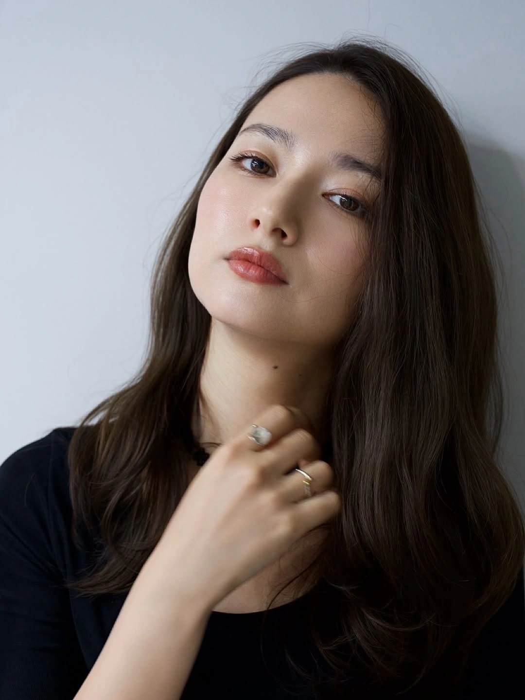 Near-black long hair with center part and softly curved ends
