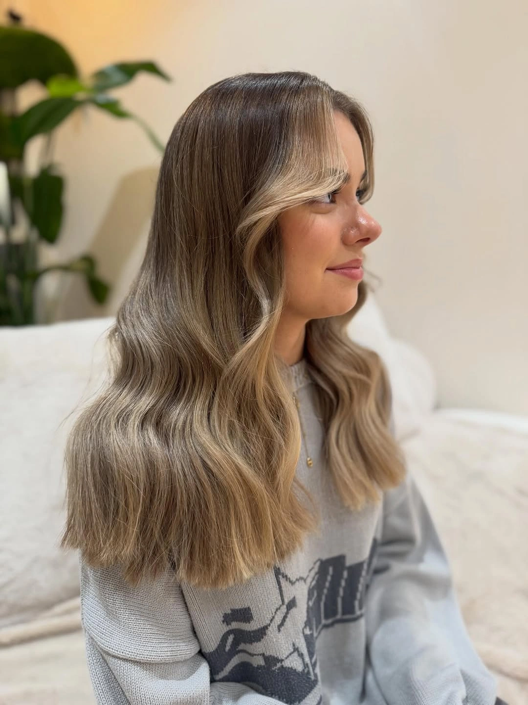Smoky brunette waves with one pale face-framing streak and side part