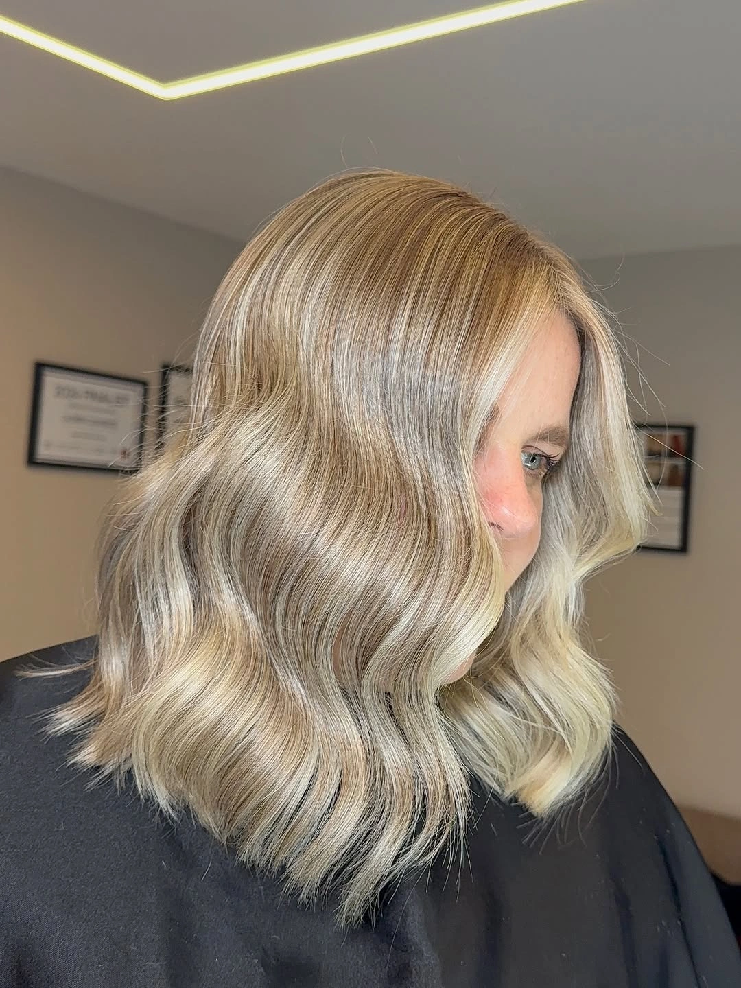 Short pearly blonde bob with glossy sculpted S-waves and crown depth