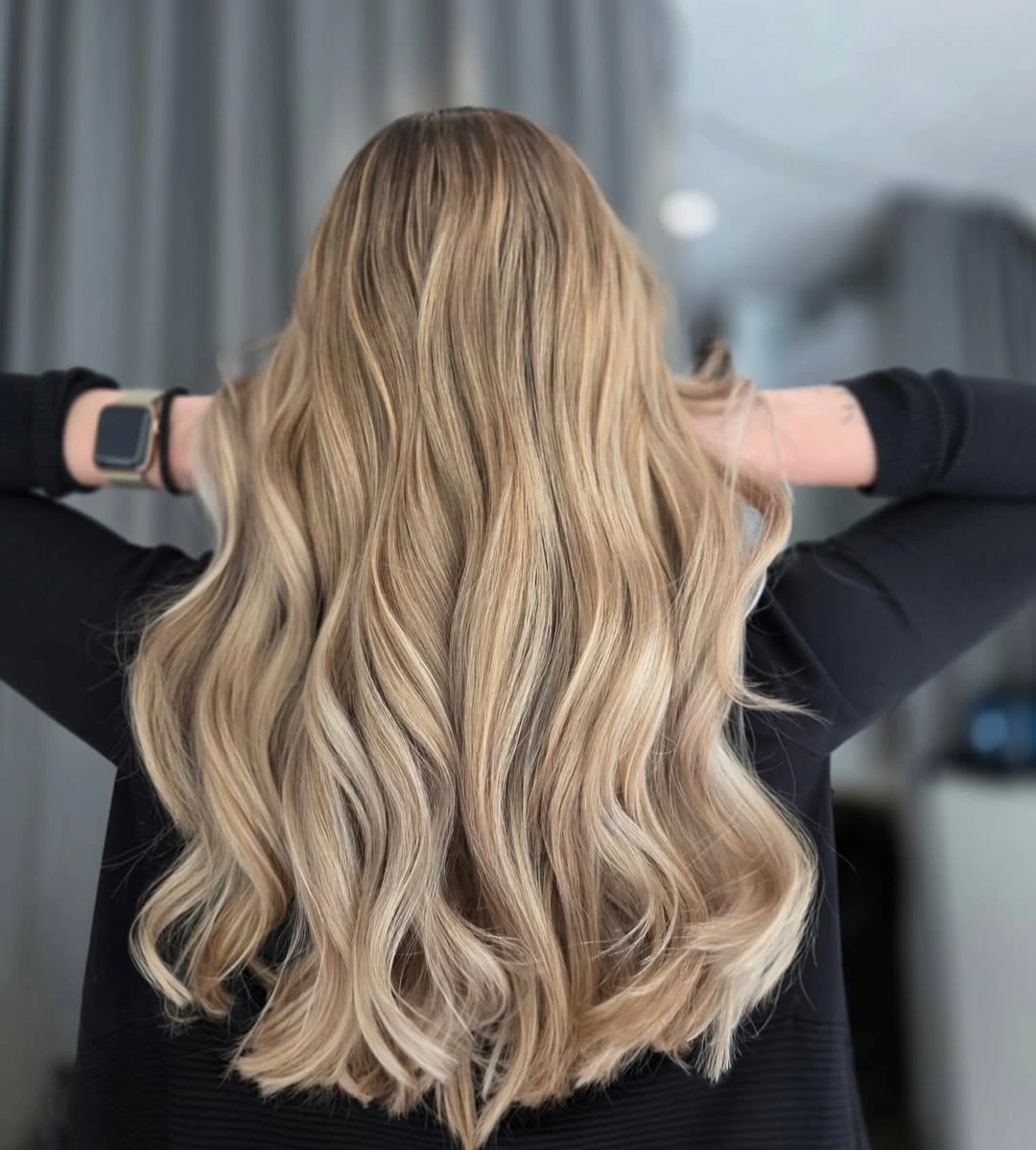 Long sandy blonde loose waves with gentle deeper crown dimension