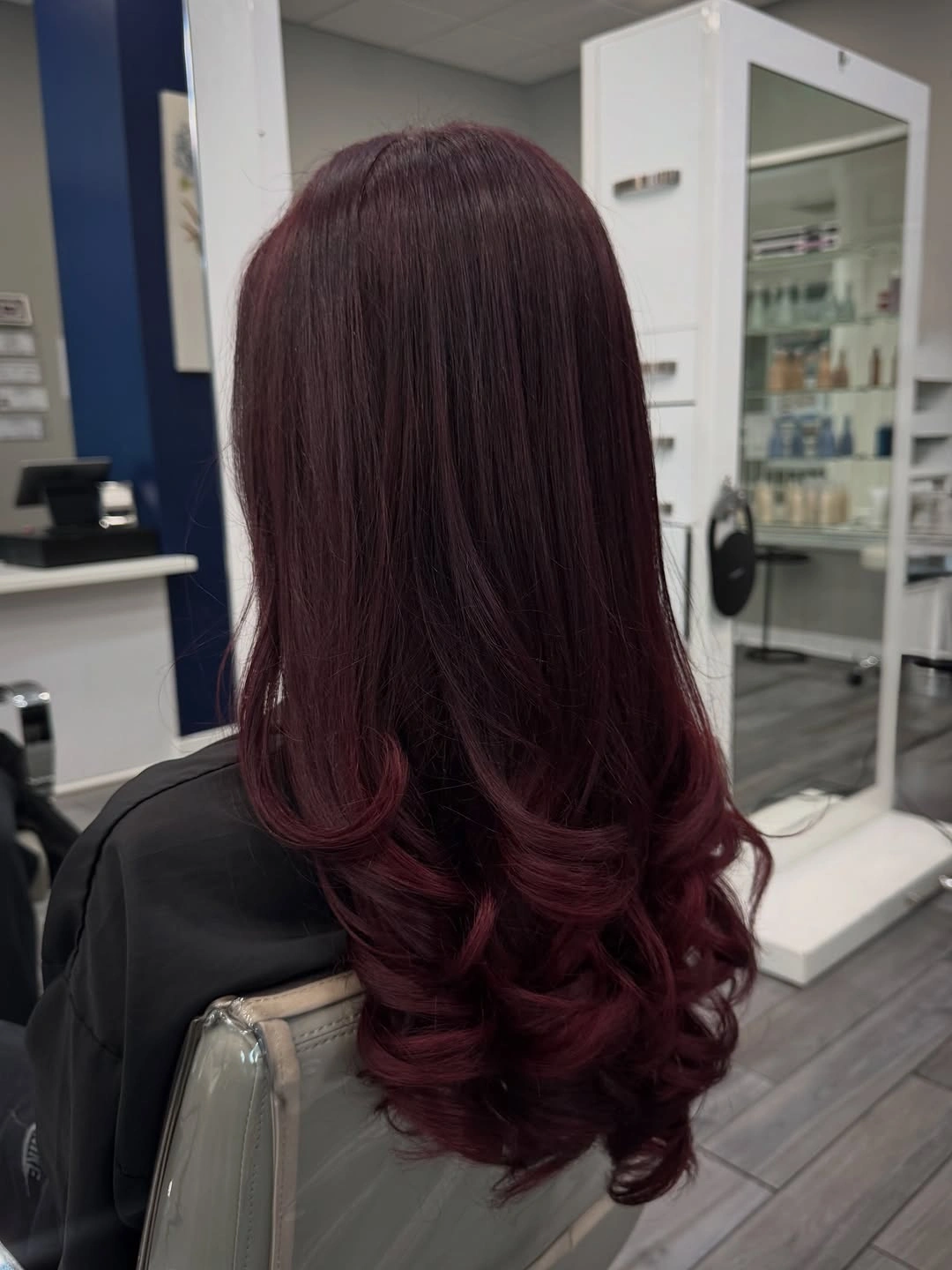 Long deep burgundy hair with smooth roots and loose curled ends
