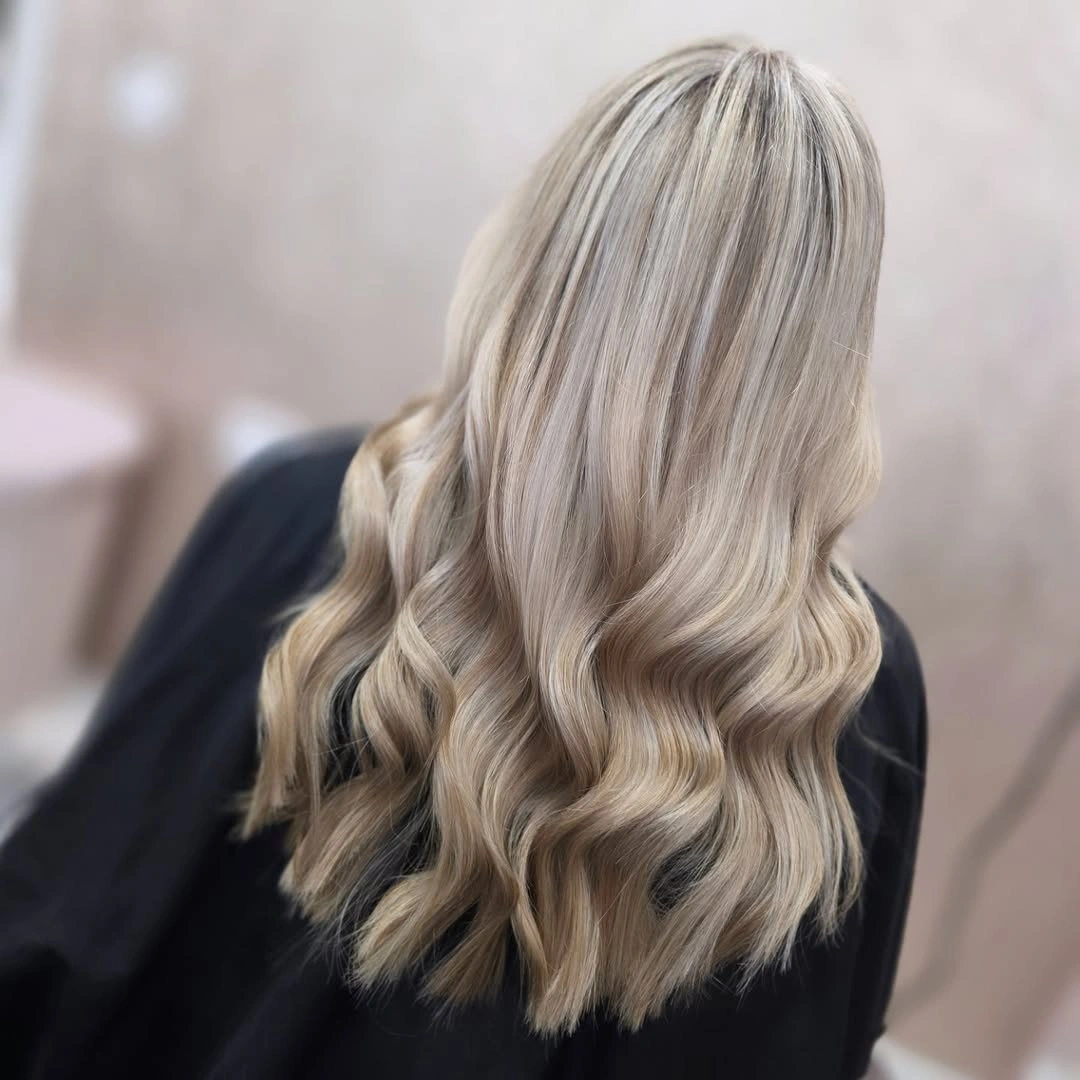 Long cool beige blonde waves with darker crown ribbons