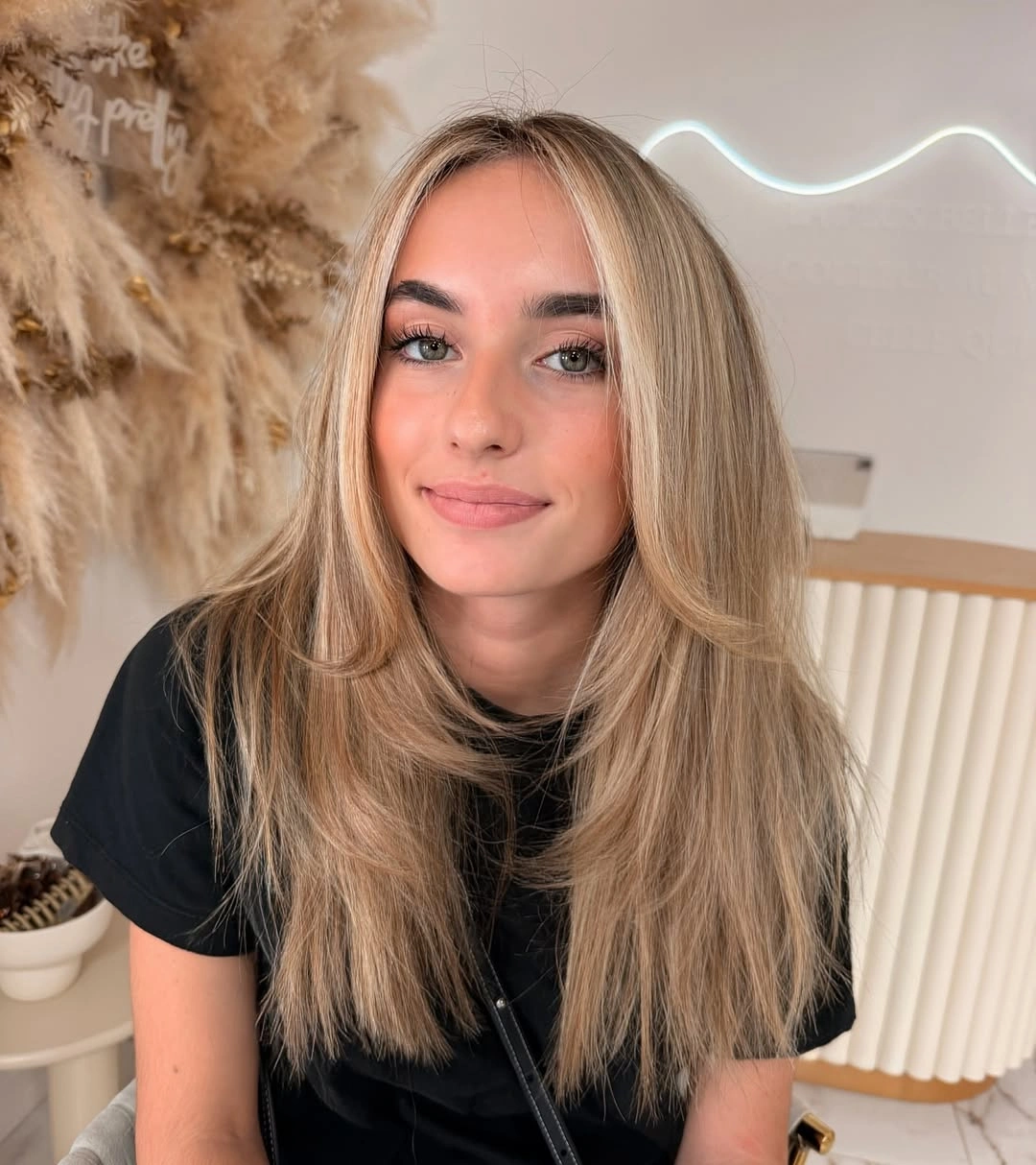 Long taupe beige blonde hair with muted roots and fine ends