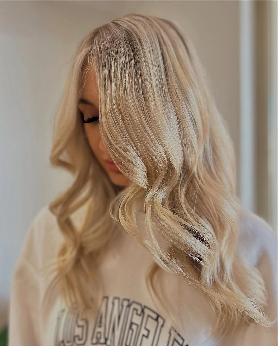 Long creamy blonde waves with pale front-swept hair