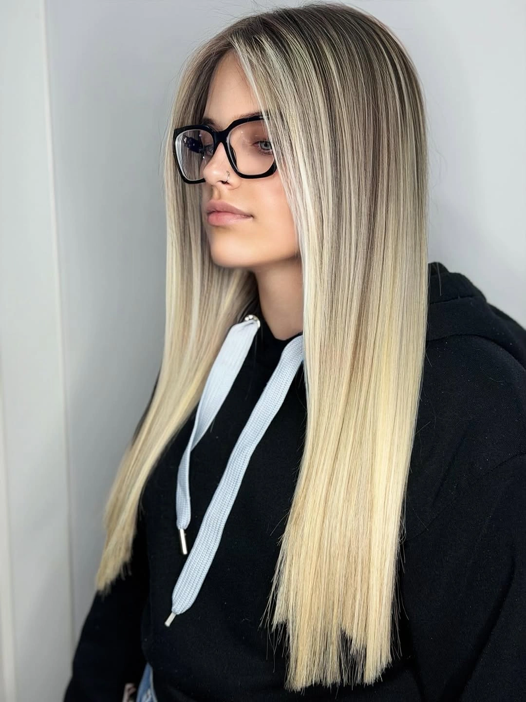 Very long straight blonde hair with darker roots and pale face pieces