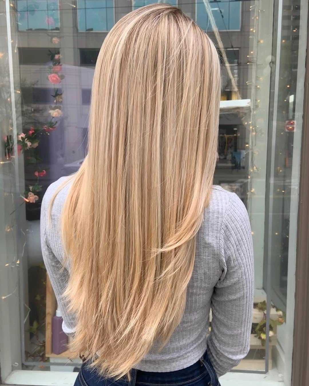 Very long straight beige blonde hair with subtle root depth