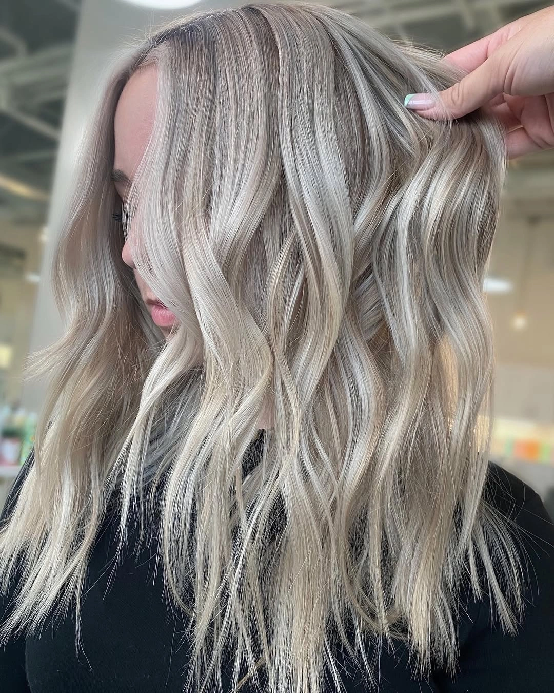 Medium choppy ash blonde waves with silvery face pieces