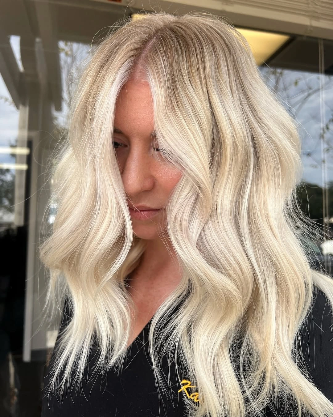 Medium pale blonde waves with bright creamy face framing