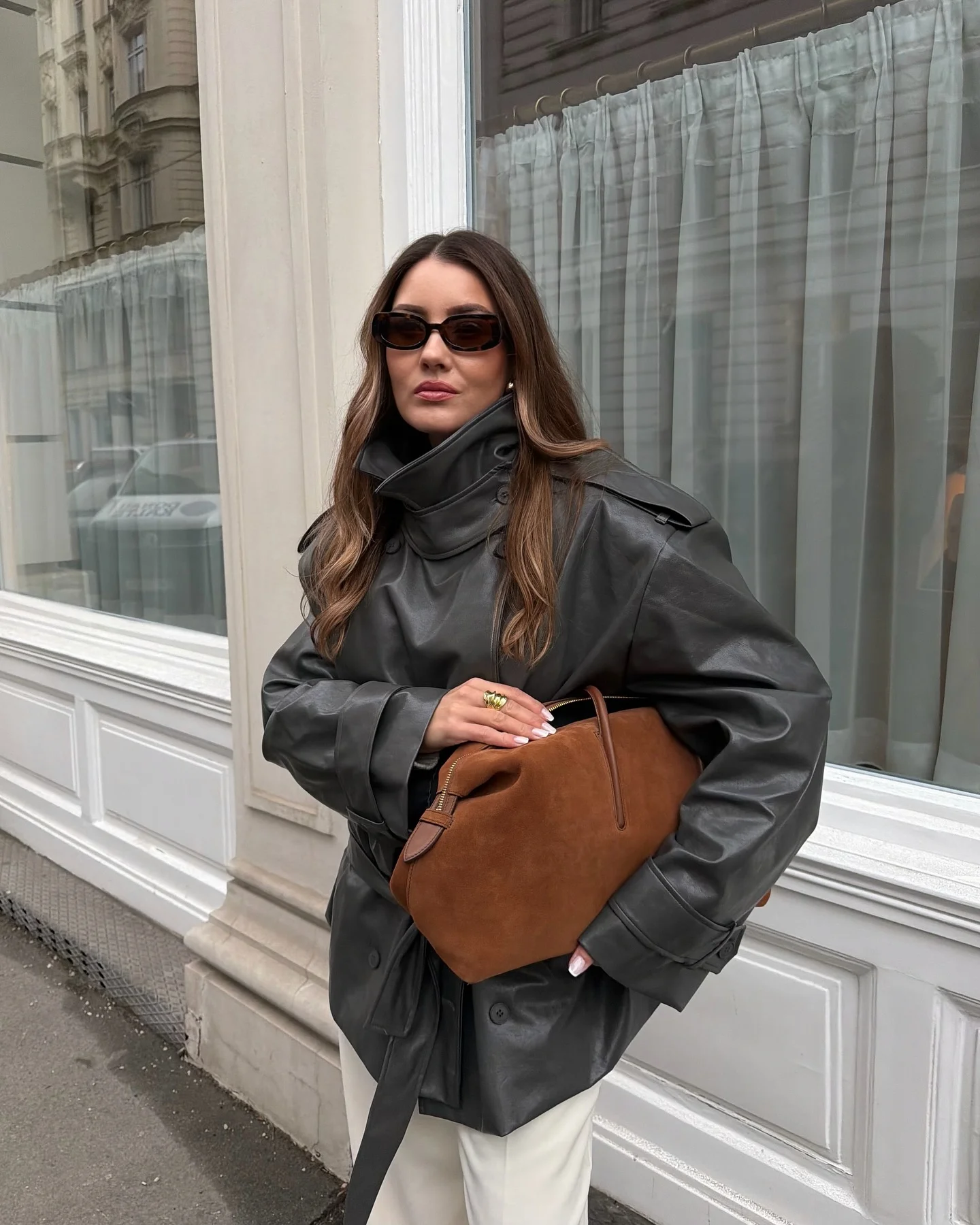 Charcoal oversized jacket with white wide-leg trousers and brown shoulder bag