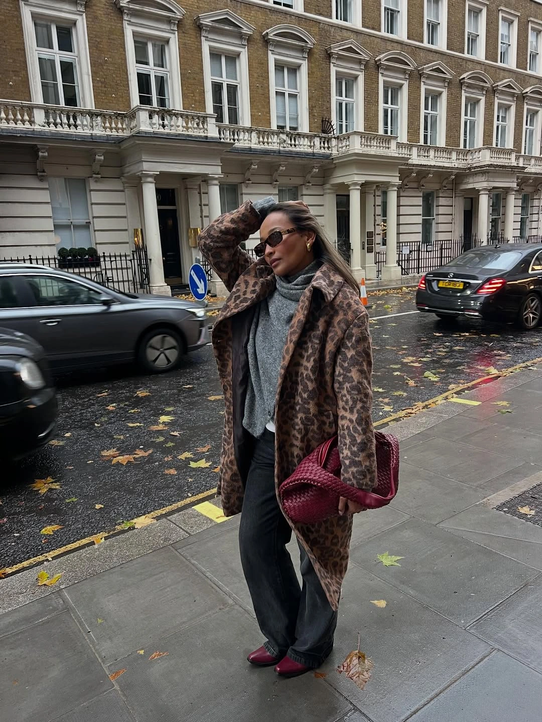 Animal-print textured coat with burgundy bag, shoes, and dark trousers
