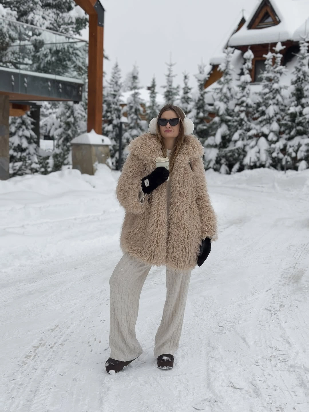 Pale beige shaggy-looking jacket with cream wide trousers and black gloves