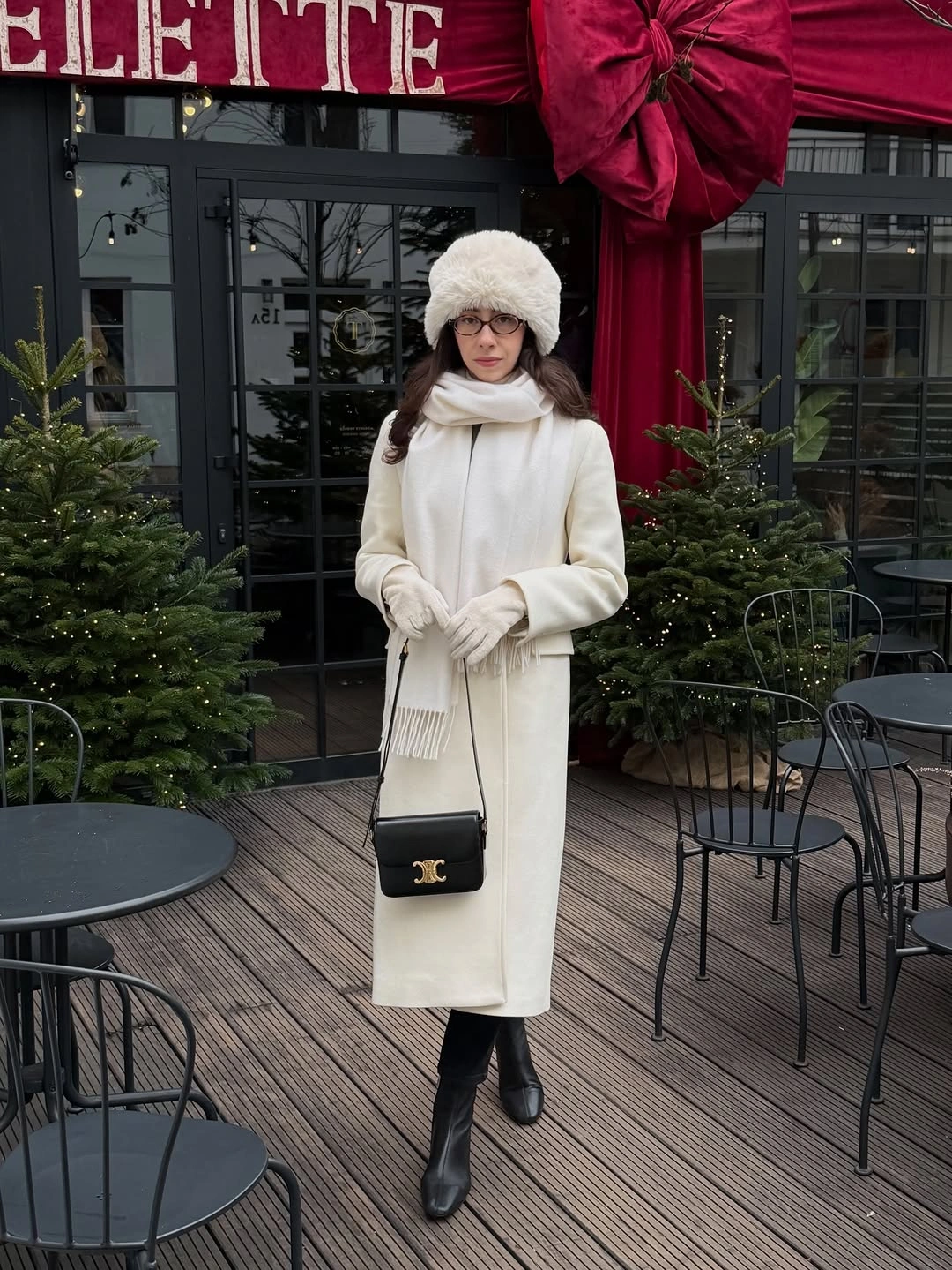 Long off-white coat with pale scarf hat and black boots