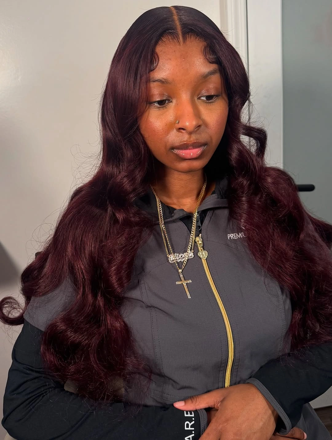 Long wine-burgundy waves with center part and smooth crown