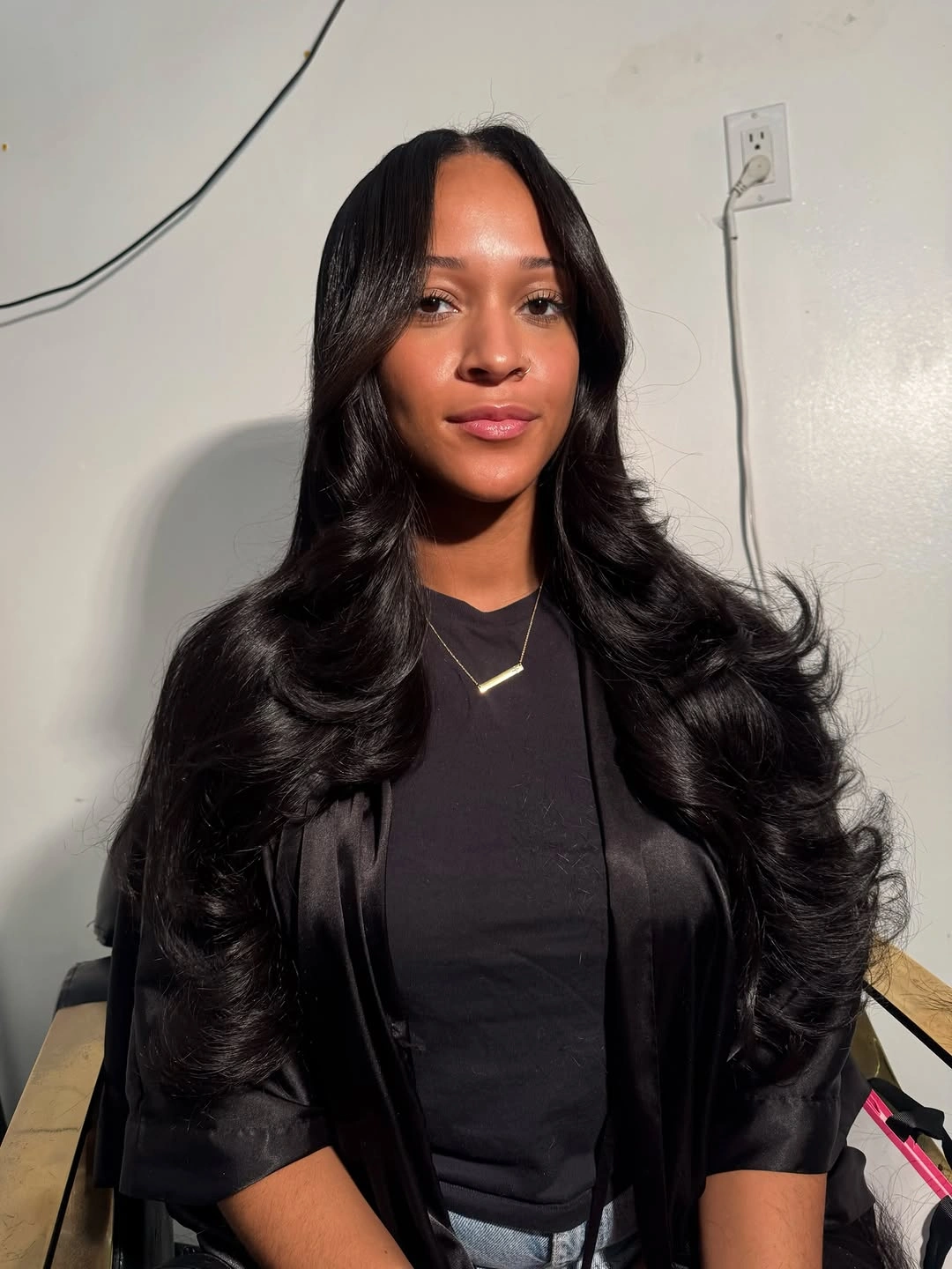 Long glossy black waves with center part and lower curls