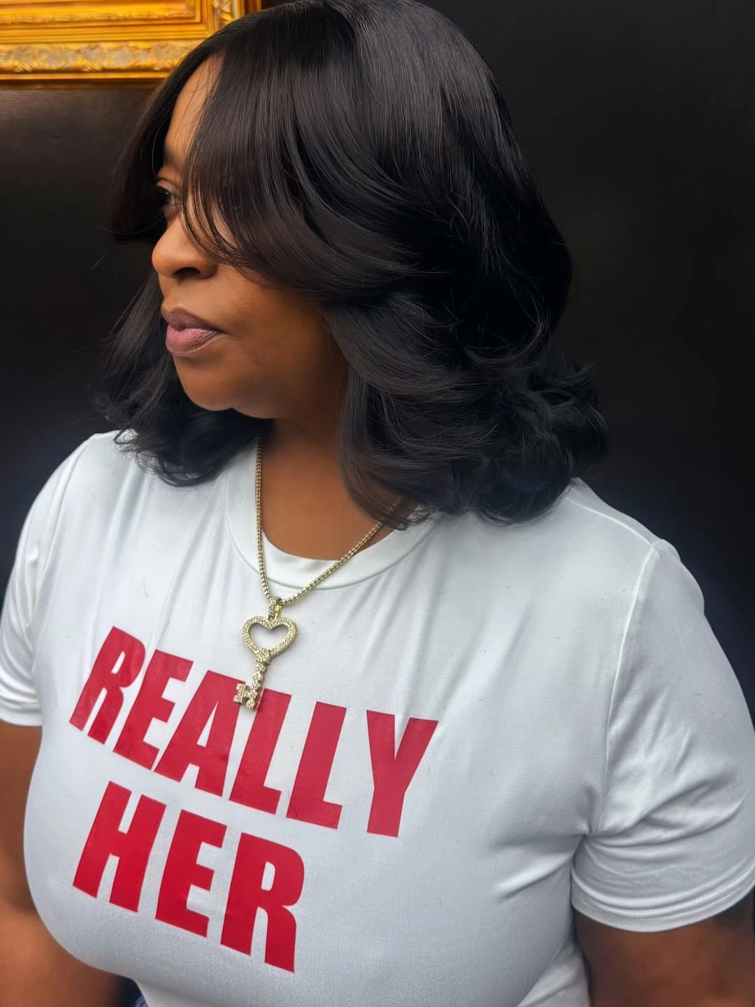 Shoulder-length near-black layers with side-swept front and curled ends