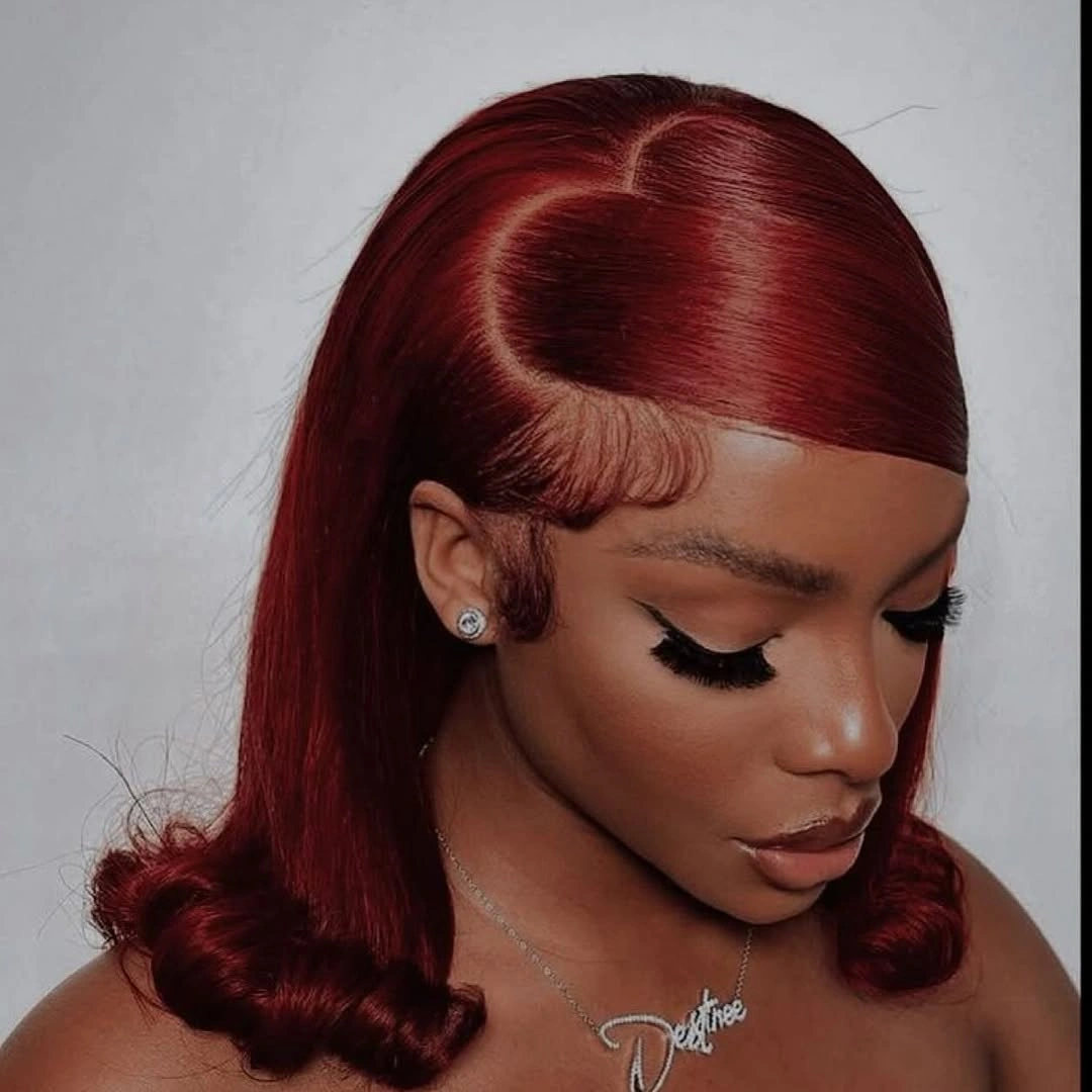 Sleek ruby-red shoulder-length hair with side part and curled ends