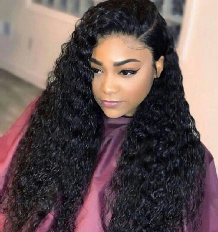 Very long black curly hair with deep side part