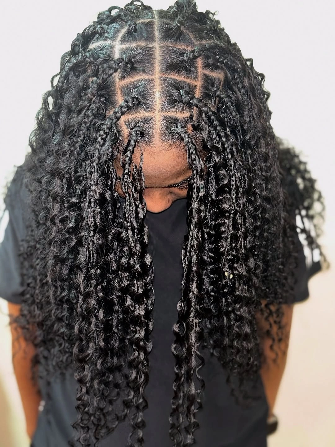 Dark square-parted curls with glossy rope-like front pieces
