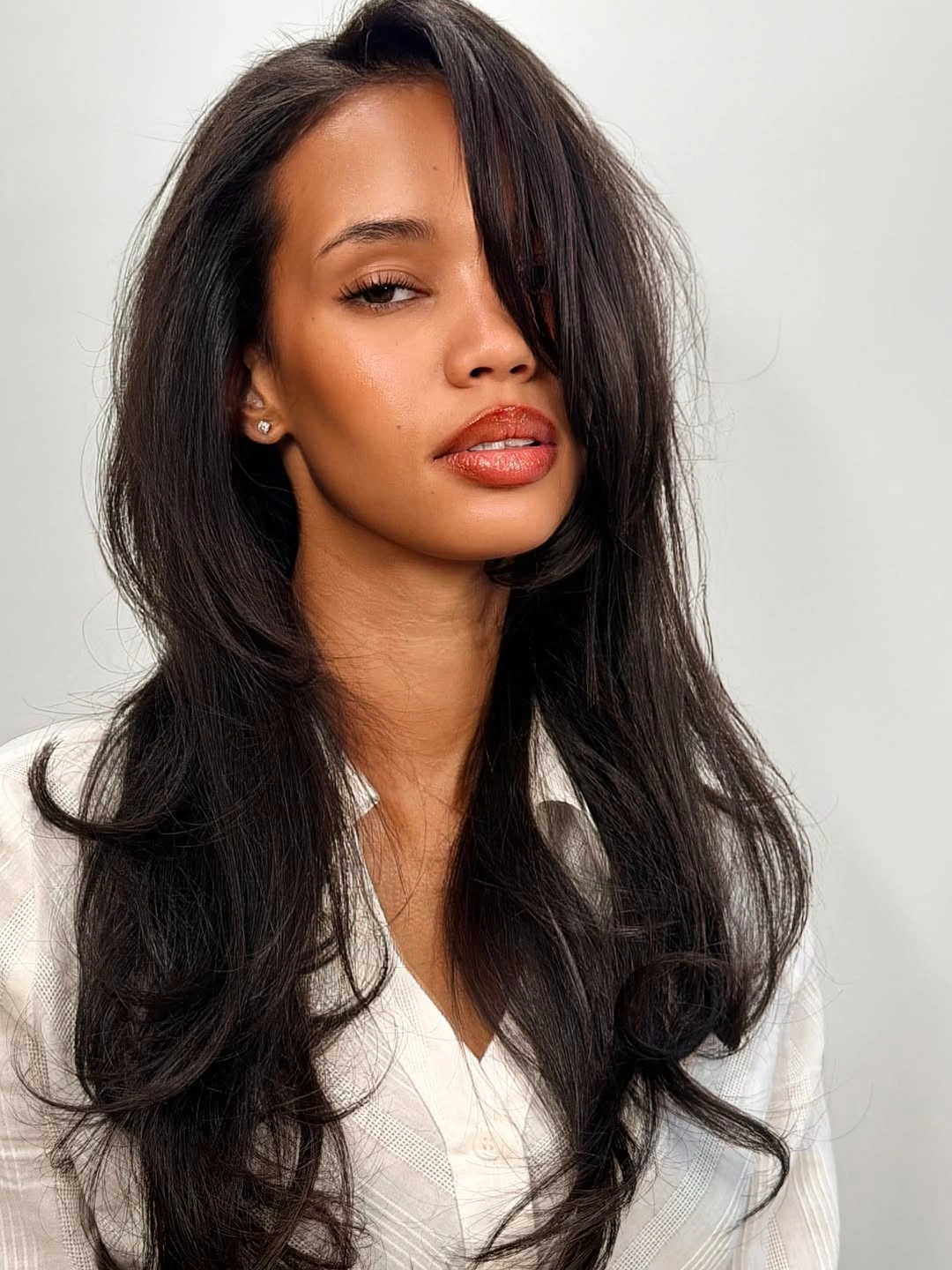 Near-black long layered waves with heavy side-swept front