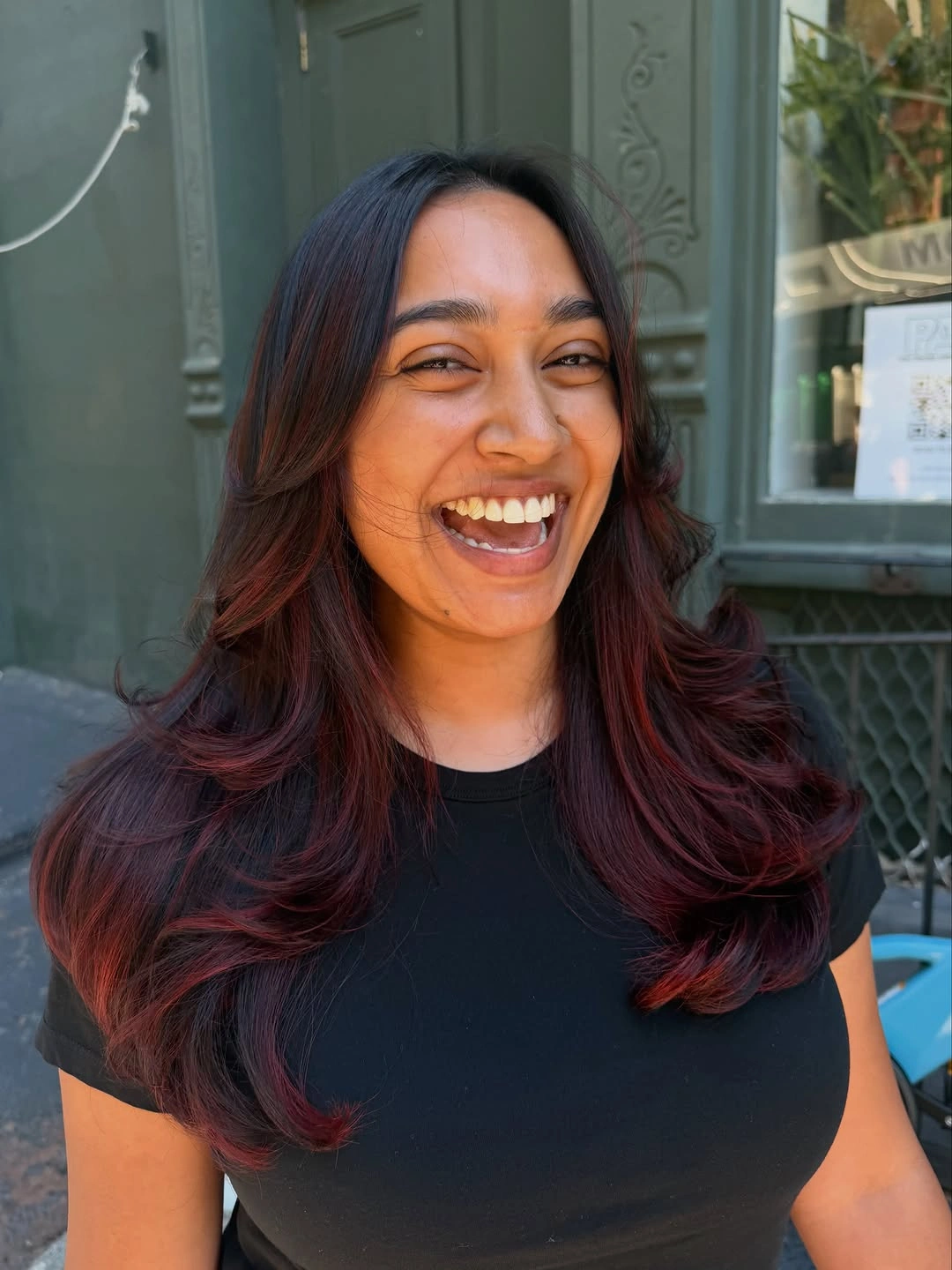 Dark layered waves with burgundy-red midlengths and curled ends