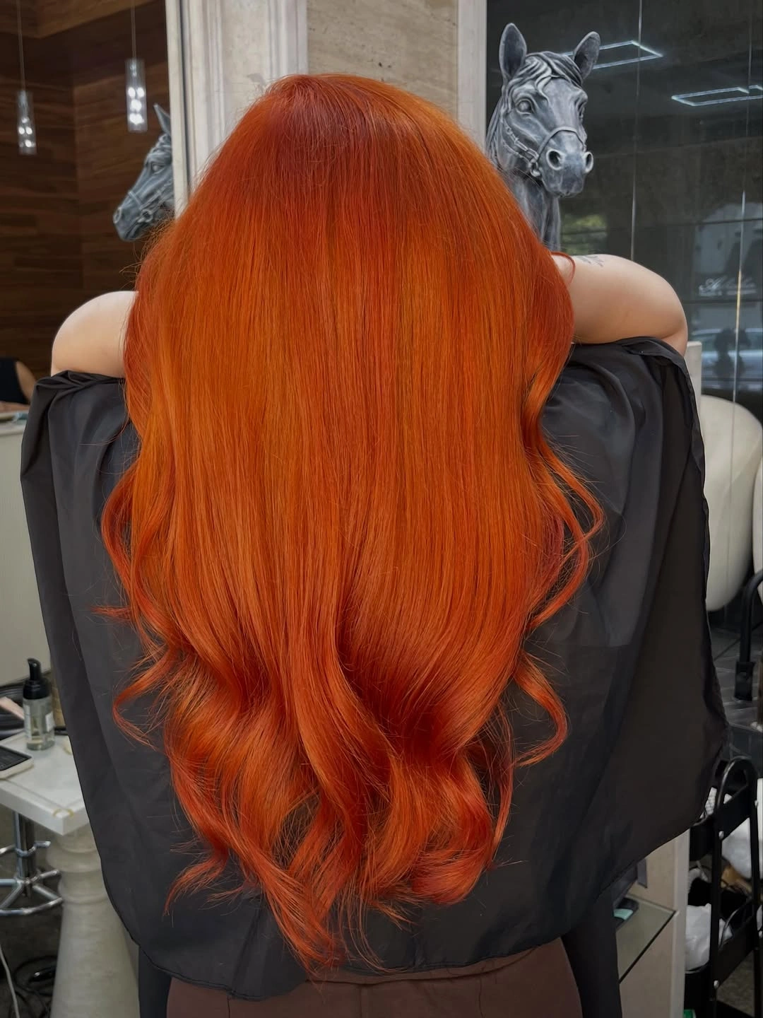 Very long saturated orange copper hair viewed from the back