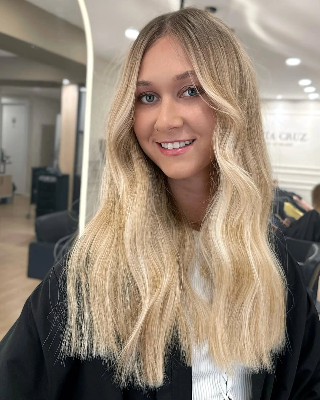 Long creamy blonde hair with sandy roots and soft waves