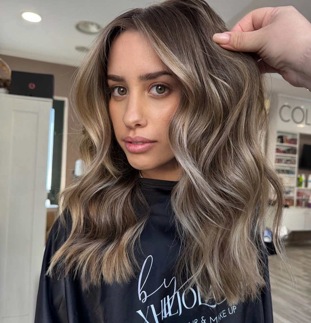 Shoulder length brunette waves with ash beige face framing pieces