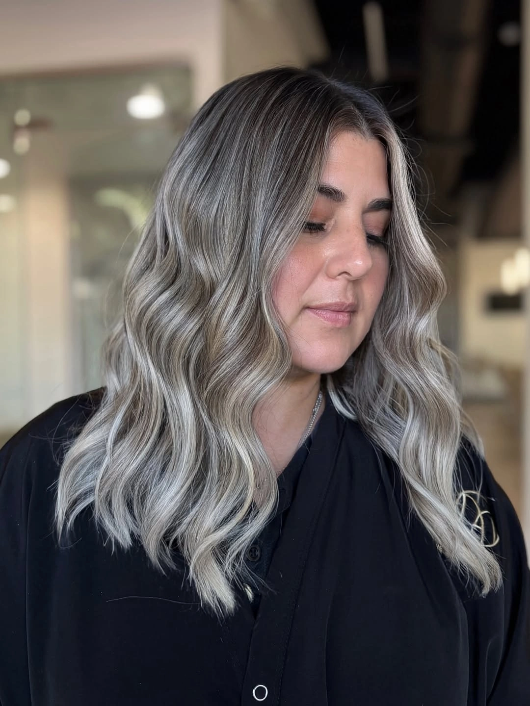 Shoulder length smoky silver ash hair with dark roots