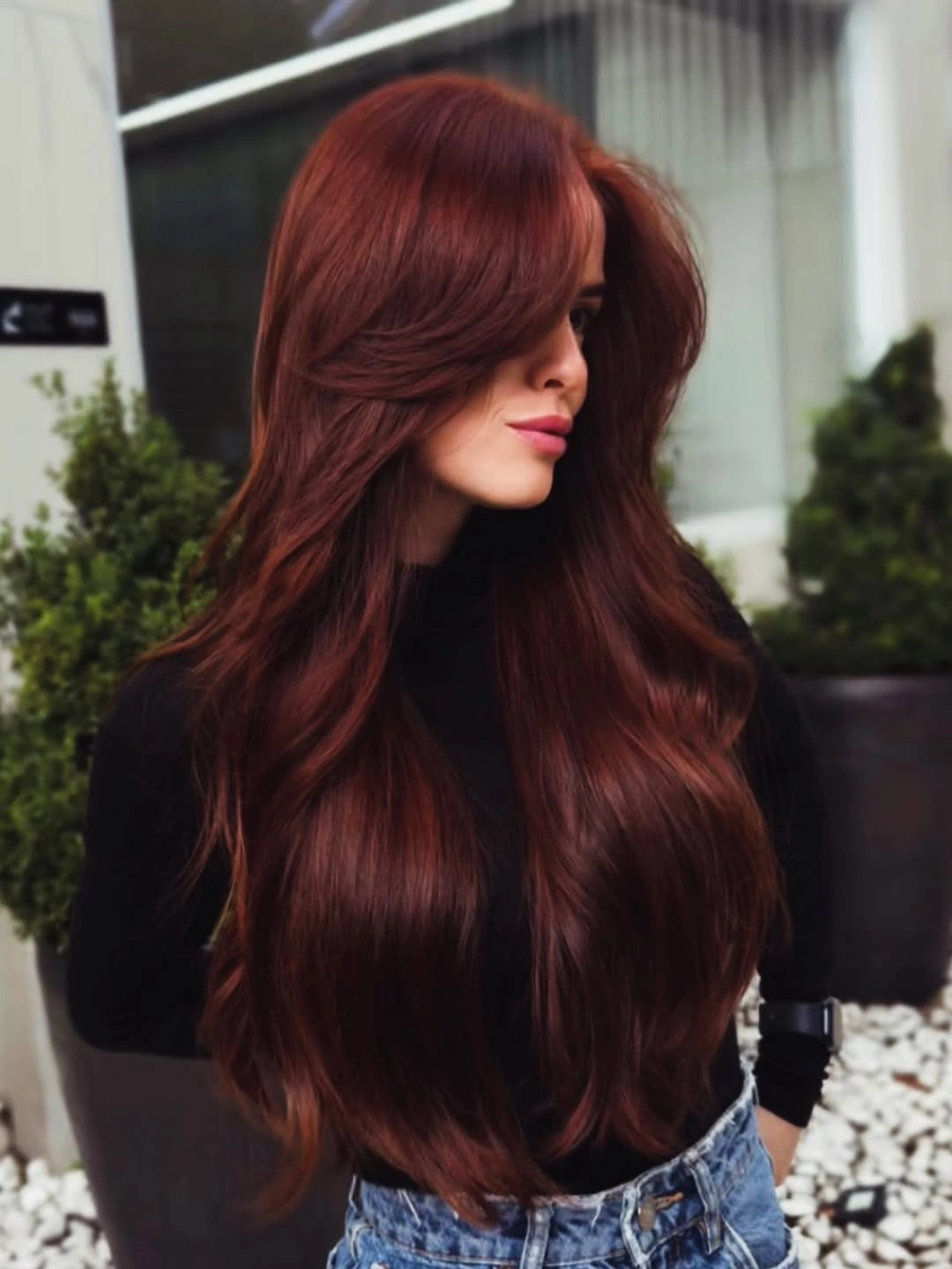 Very long deep burgundy red hair with swept layered shape