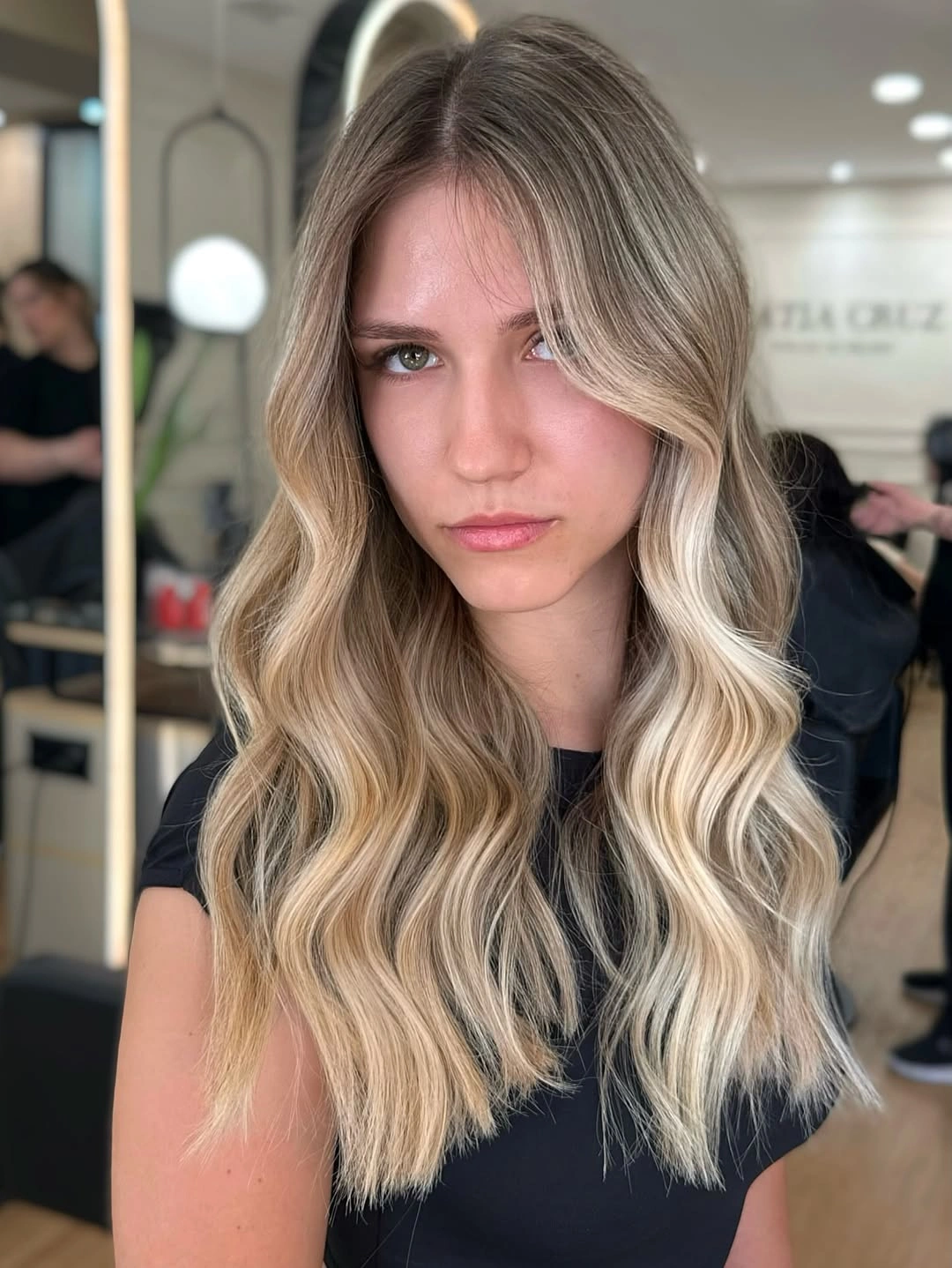 Long bronde waves with pale blonde face framing sections