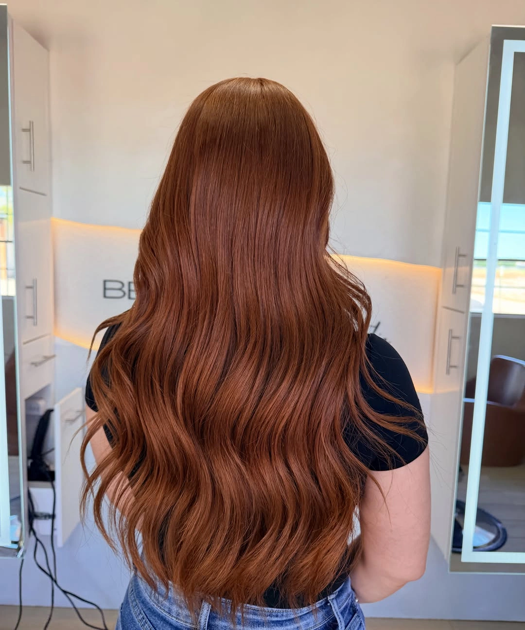 Long copper-red hair with loose waves and rounded lower edge