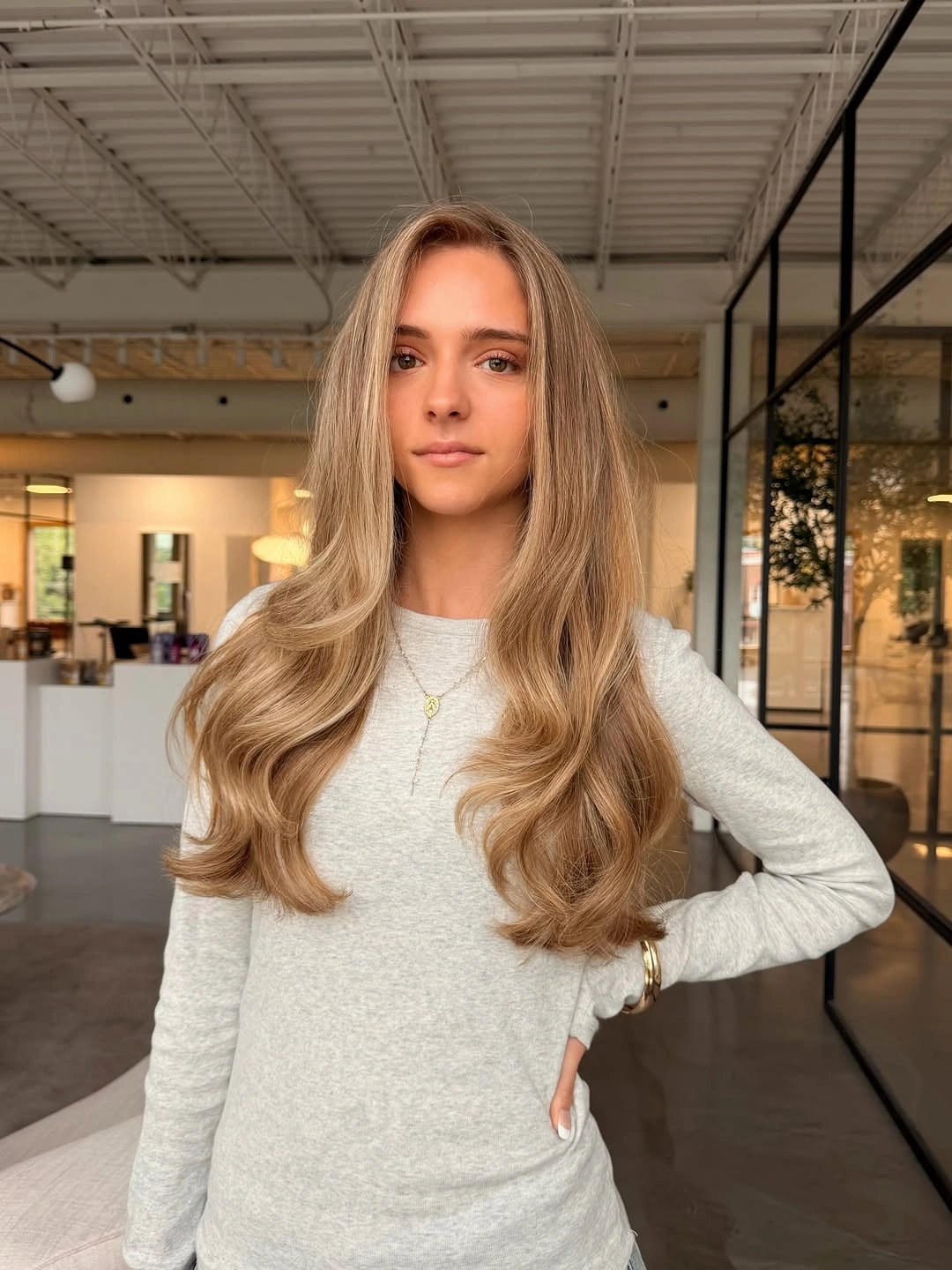 Very long blonde hair with center part and softly curved ends