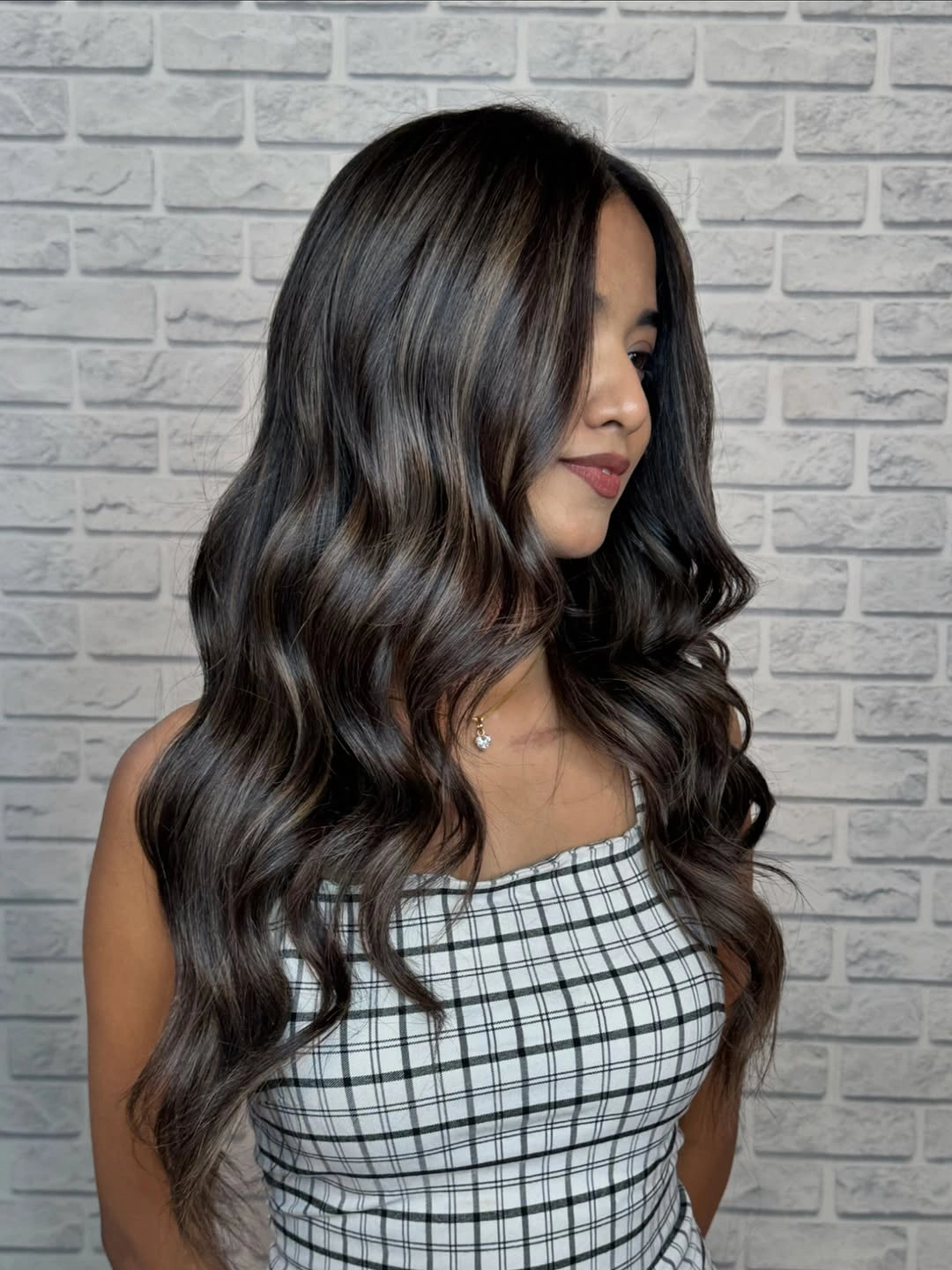 Very long dark brunette hair with broad waves and center part