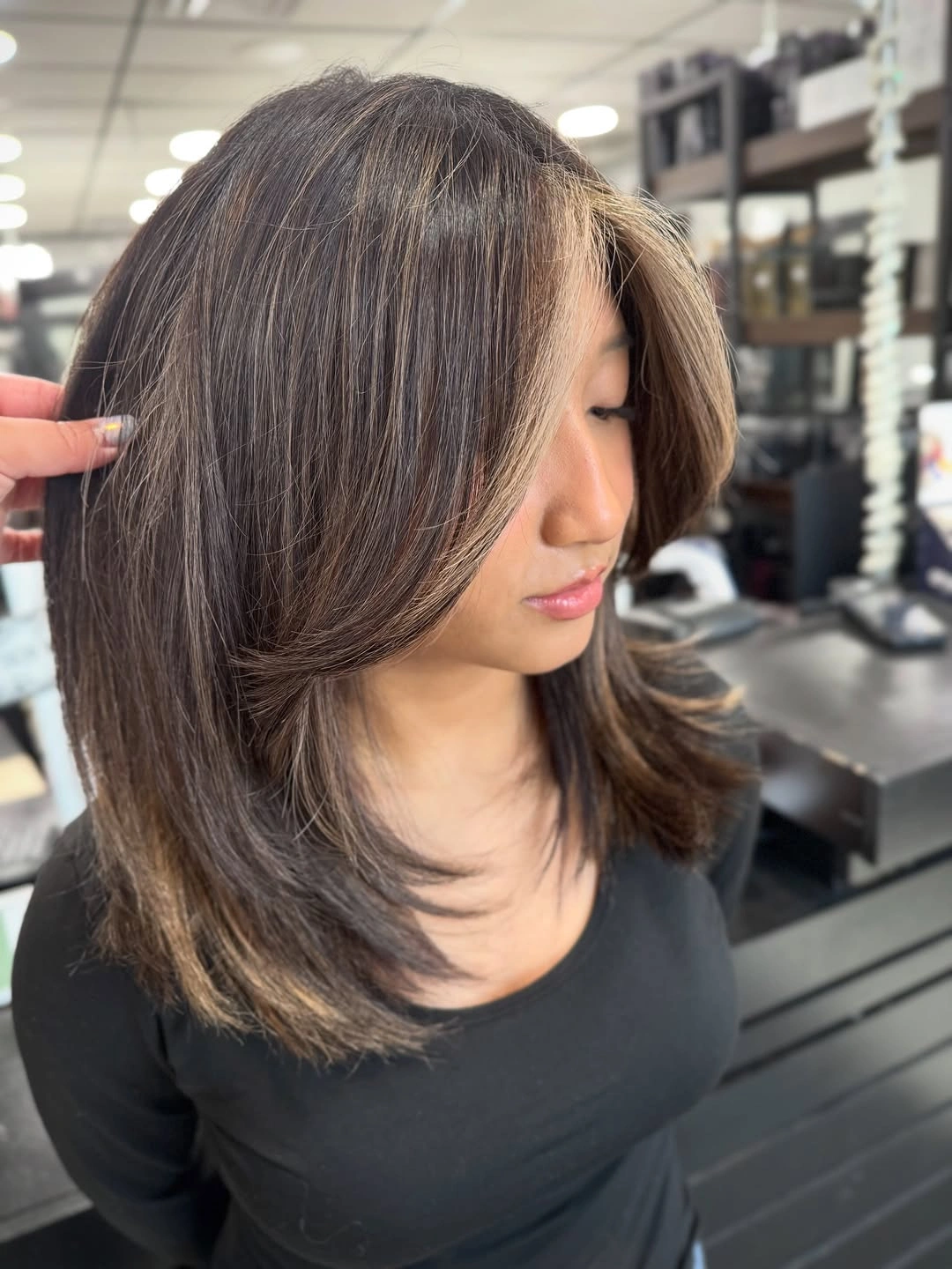 Shoulder-length brunette hair with sweeping front layers and curved ends