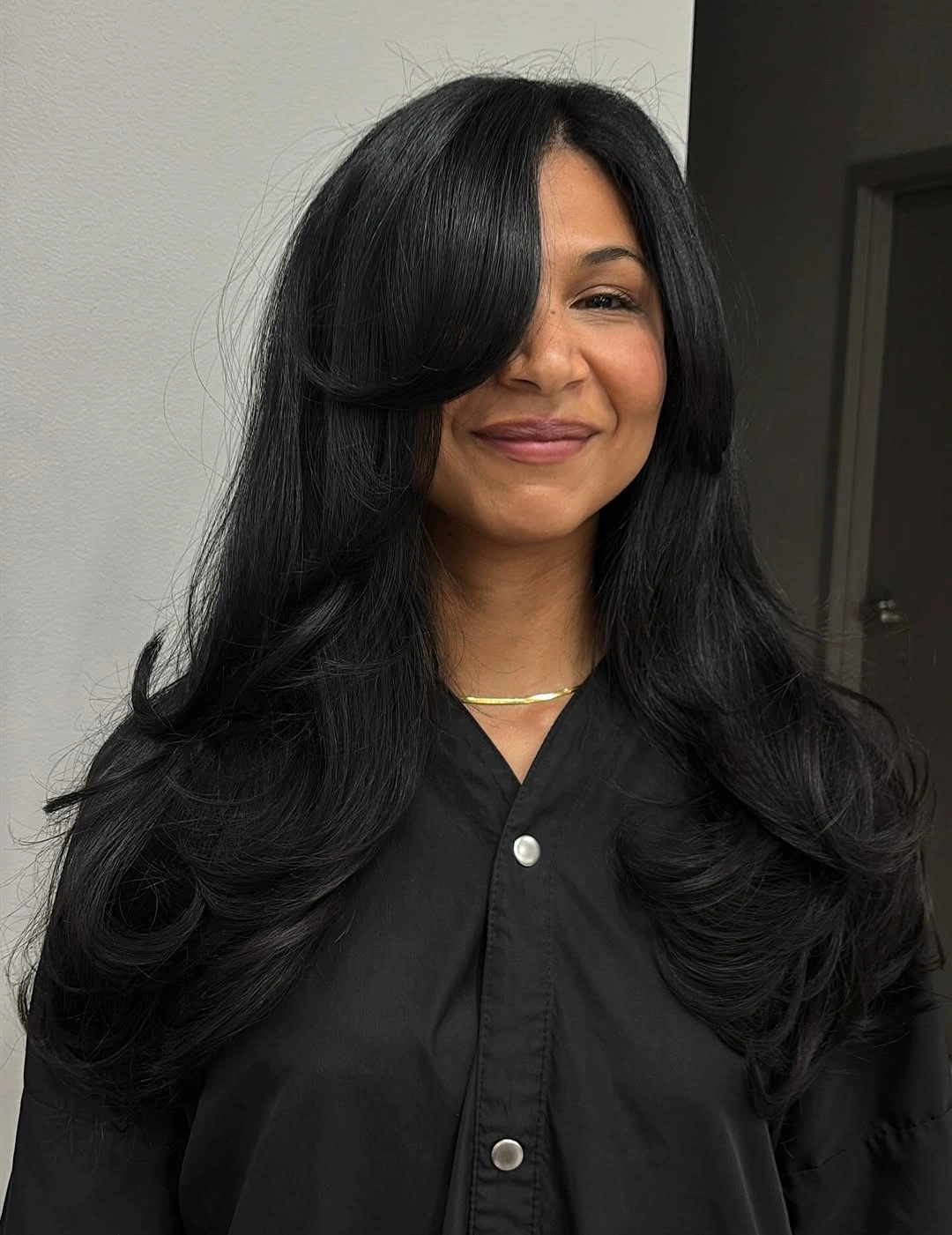 Long black layered hair with heavy side-swept front
