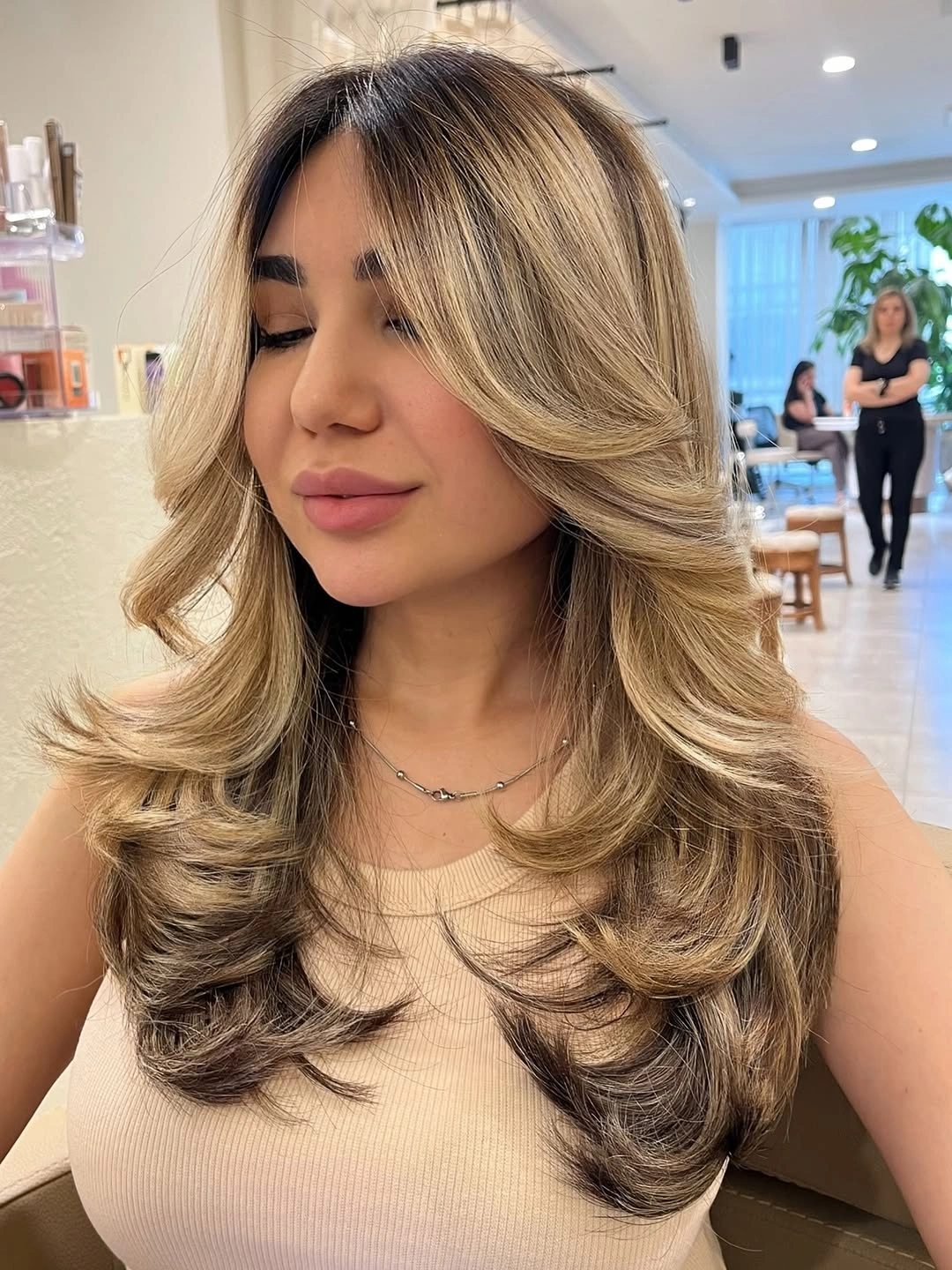Long blonde-brown layered hair with bright face-framing pieces