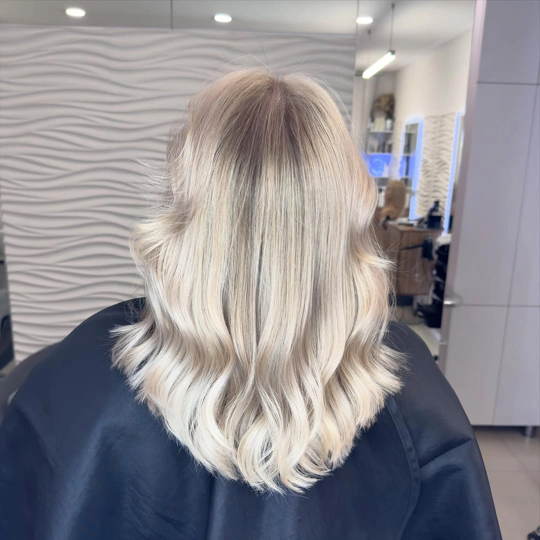 Pale blonde shoulder-length wavy haircut from the back