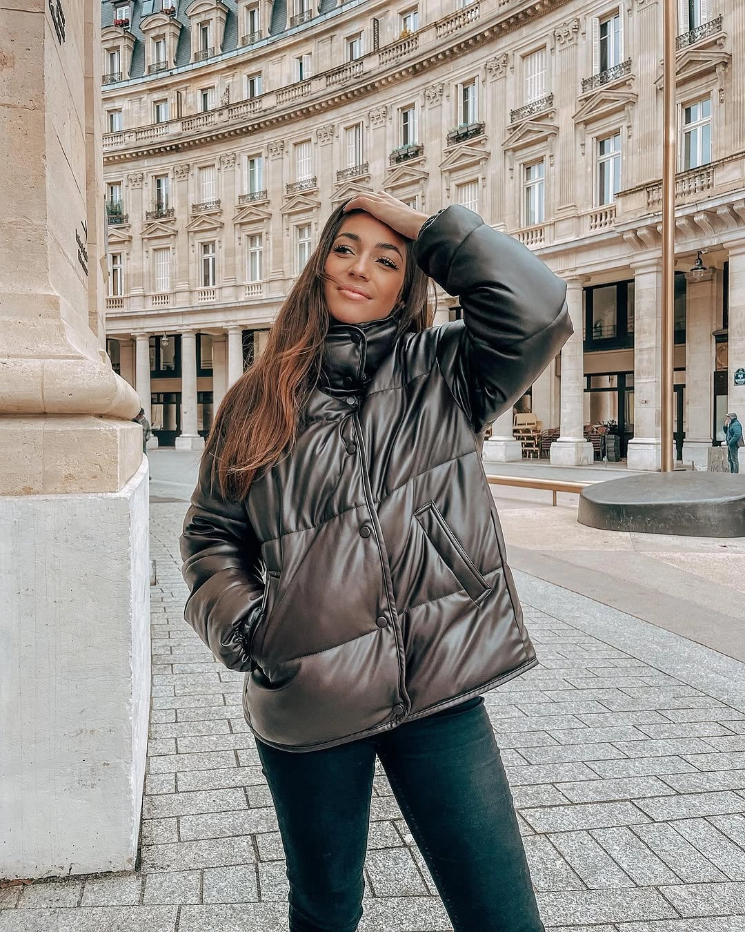 Glossy dark puffer paired with slim dark pants