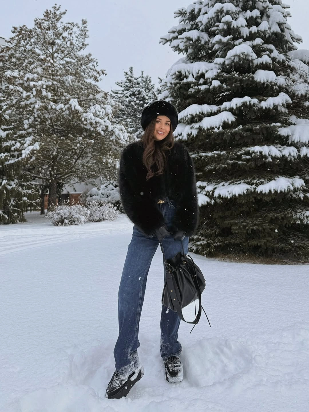 Black textured jacket with blue jeans and dark accessories