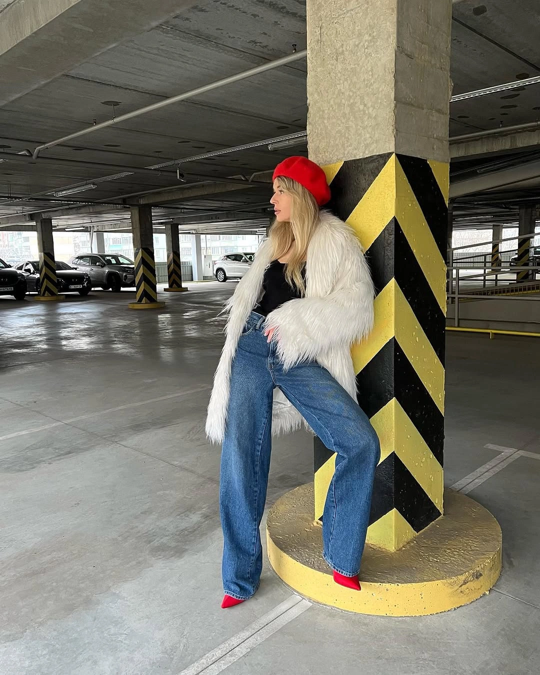 Shaggy white jacket with wide jeans and red accents